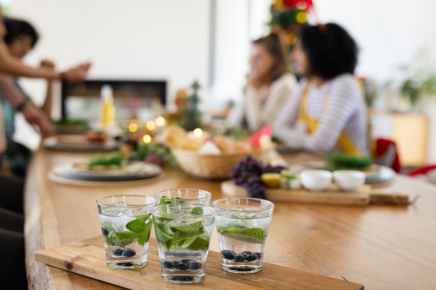 happy-diverse-friends-sitting-table-having-dinner-christmas.jpg