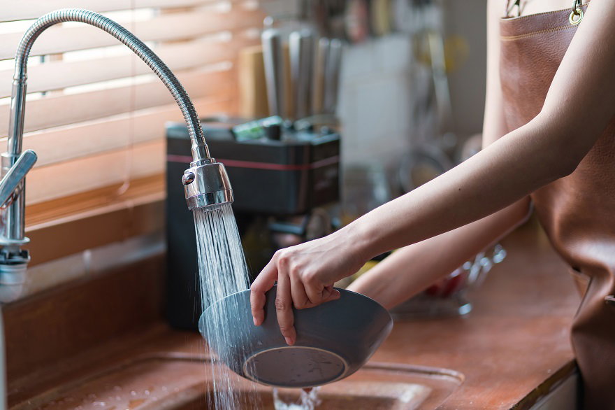 attractive-young-woman-housewife-washing-dishes-kitchen-sink-home.jpg