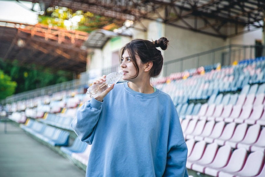 attractive-young-female-athlete-drinks-water-after-workout.jpg