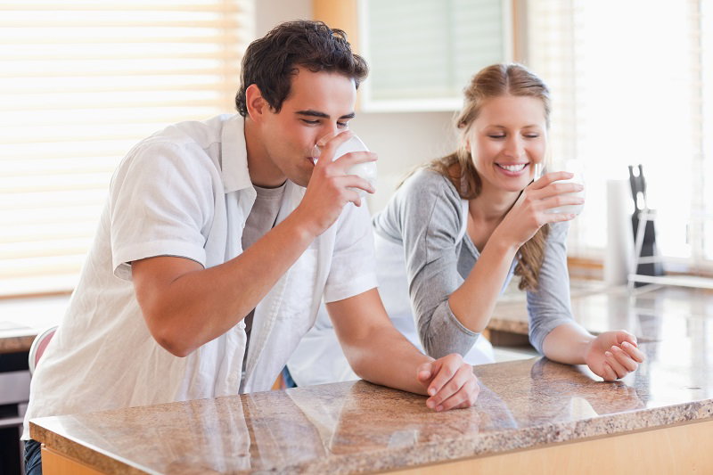 couple-drinking-milk-kitchen.jpg
