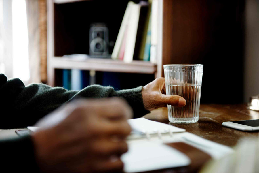 a man holding a bottle of filtered water