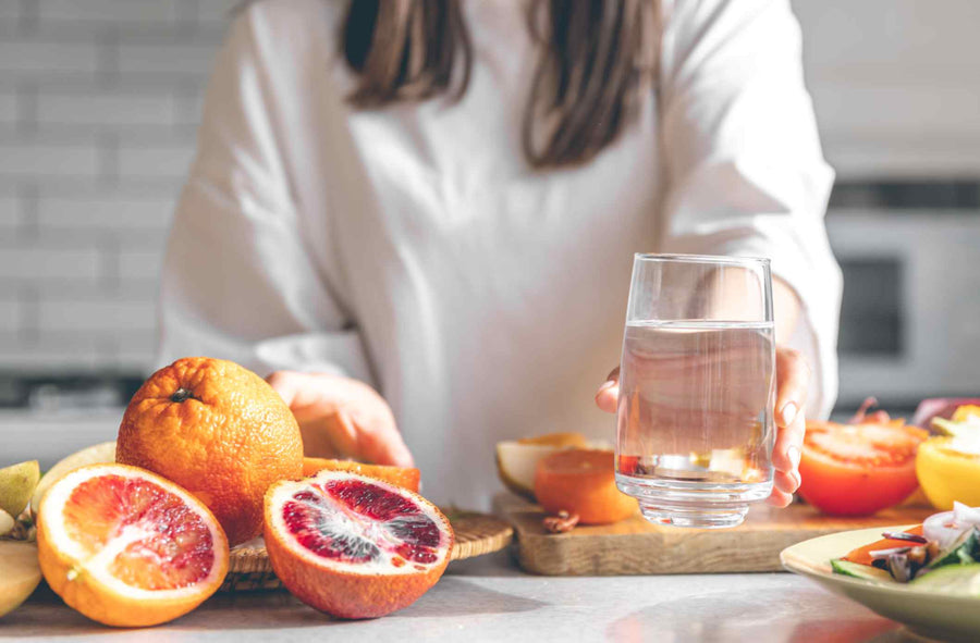 a-woman-holding-a-glass-of-filtered-water-in-the-kitchen.jpg