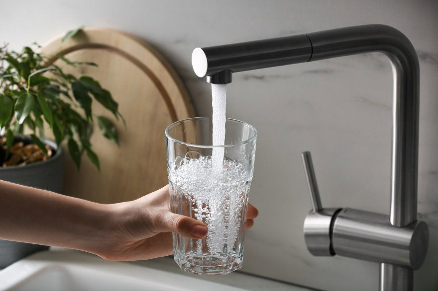woman-filling-glass-with-tap-water-from-faucet-kitchen-closeup.jpg