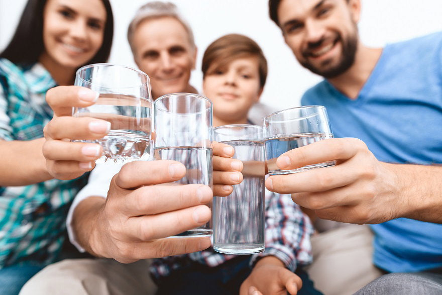 close-up-cheerful-family-cheering-with-glasses-water.jpg