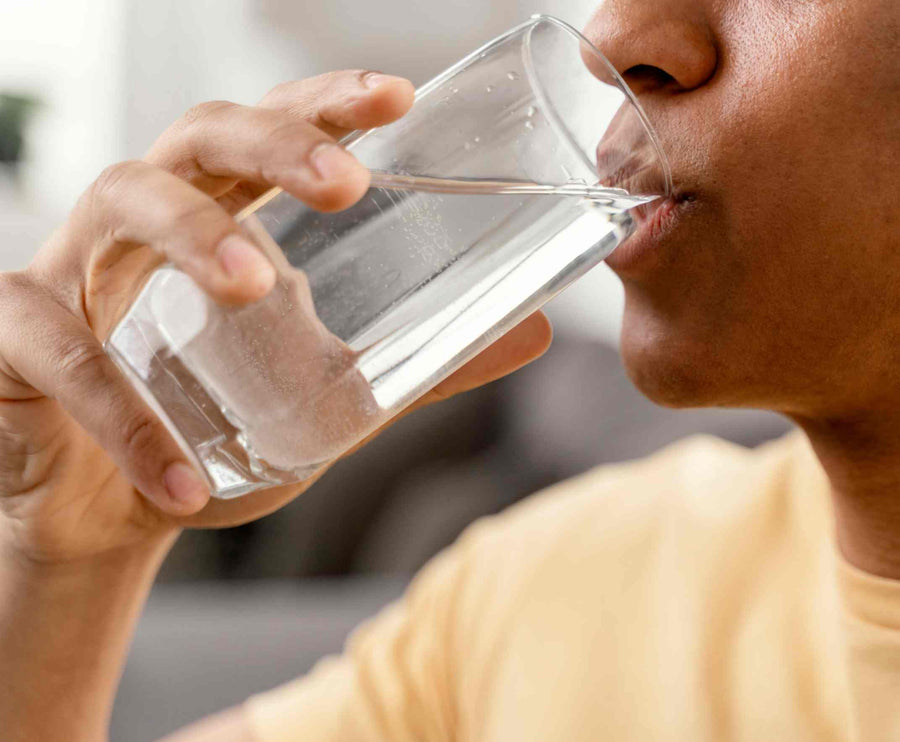 a man drinking a bottle of filtered water