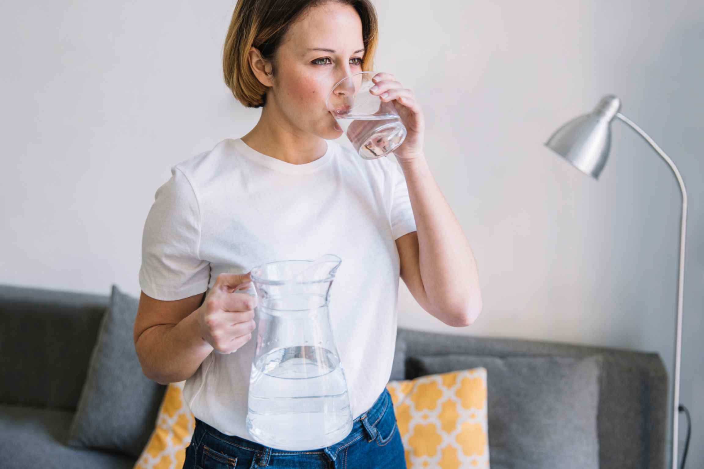 a woman is drinking filtered water