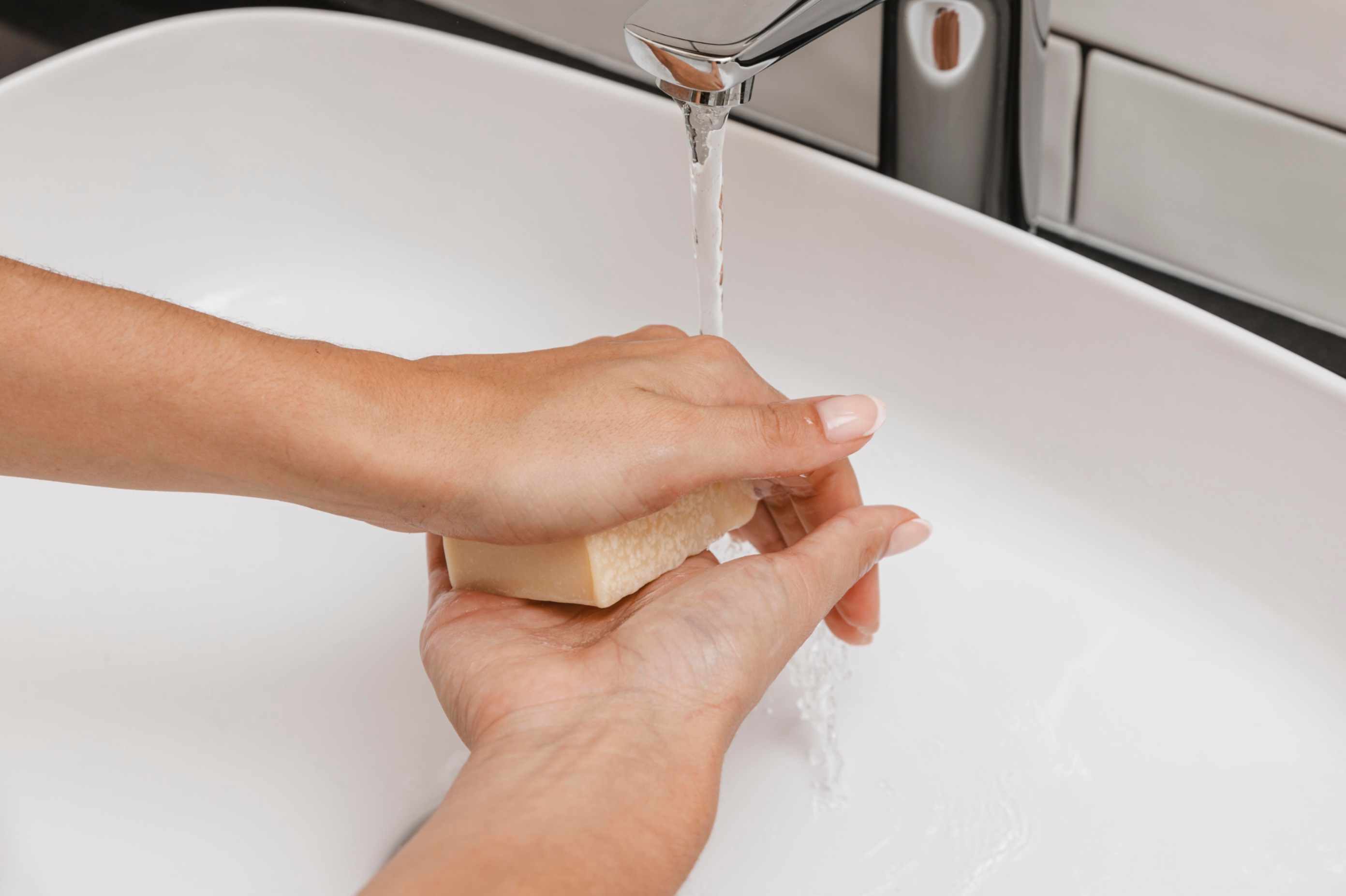 Washing hands with soft clean household water